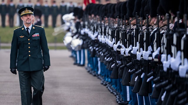 King Frederik walking past royal guards