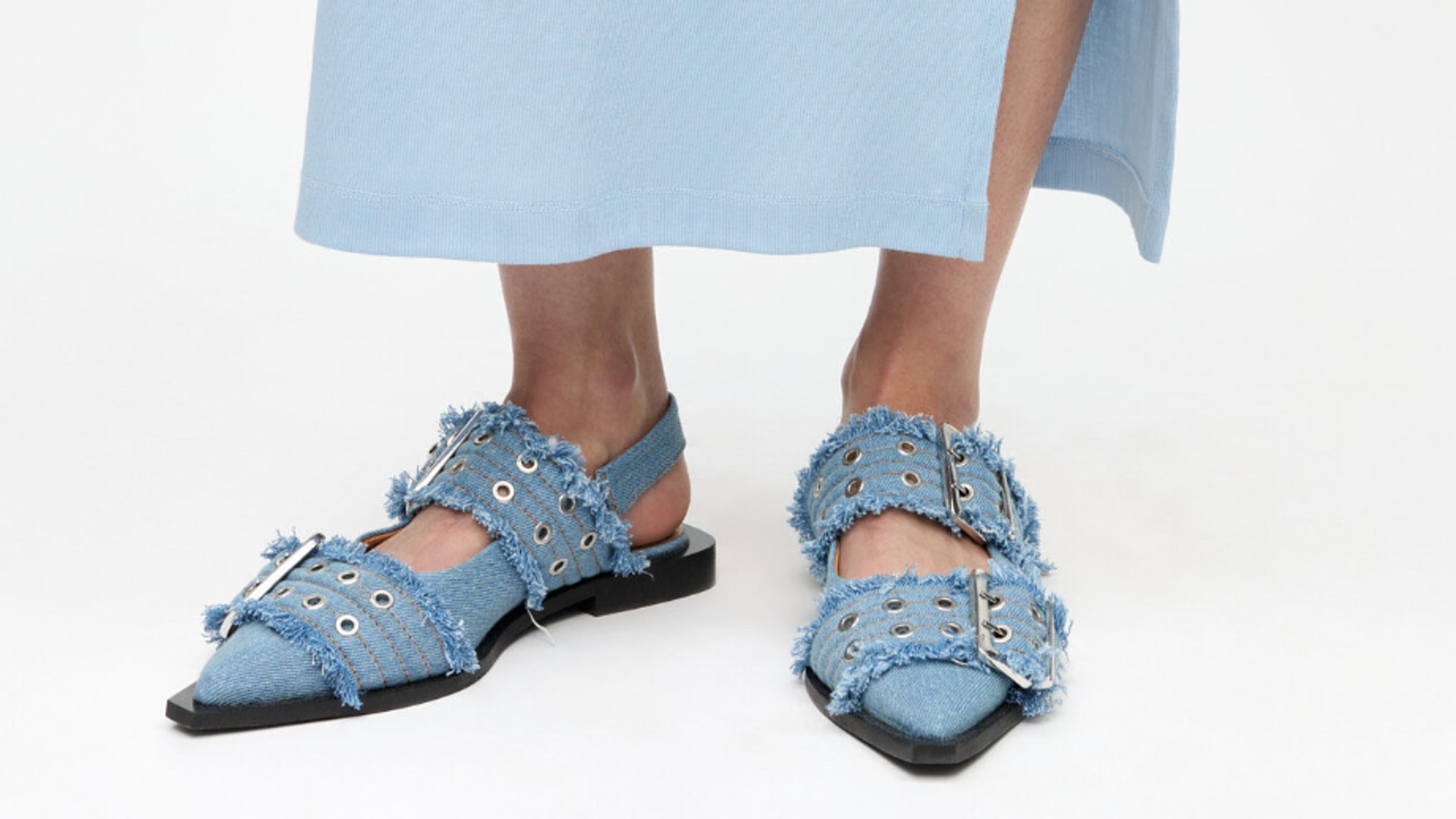 A Photo of models legs wearing denim ballet slides from Ganni