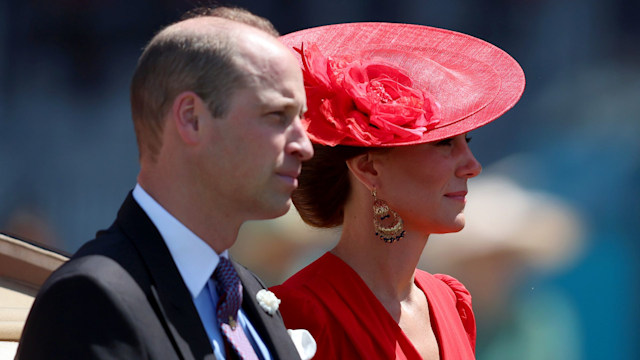 Prince William and Kate Middleton looking stoic in a carriage