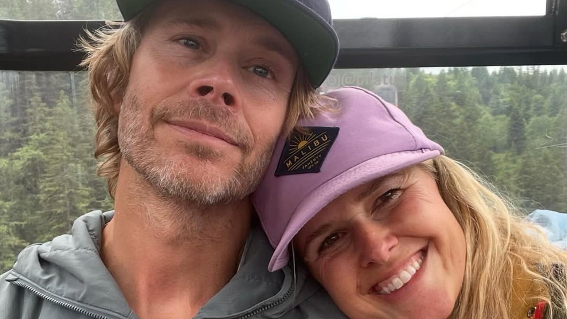 Eric Christian Olsen sits with wife Sarah cuddling into his shoulder