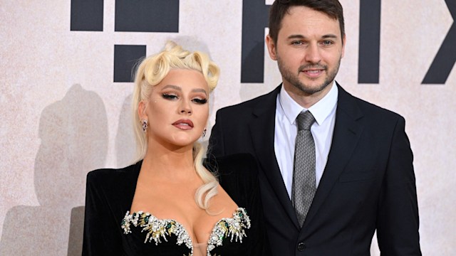 Christina Aguilera wows in plunging black dress as she joins Matthew Rutler 