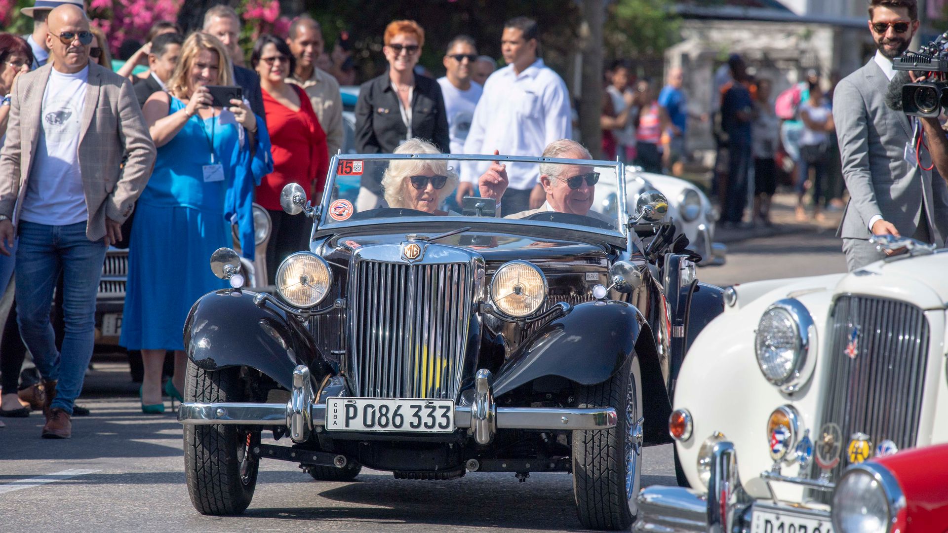 King Charles and Queen Camilla driving a classic car in Cuba