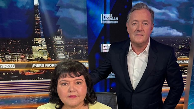 Piers Morgan next to Fiona Harvey, who is sitting in a chair