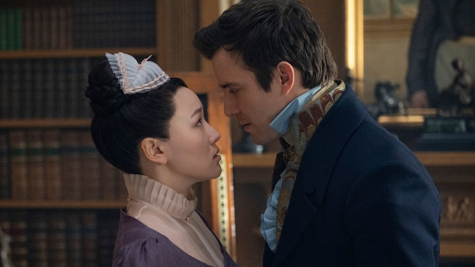 maid and lord standing opposite each other in library