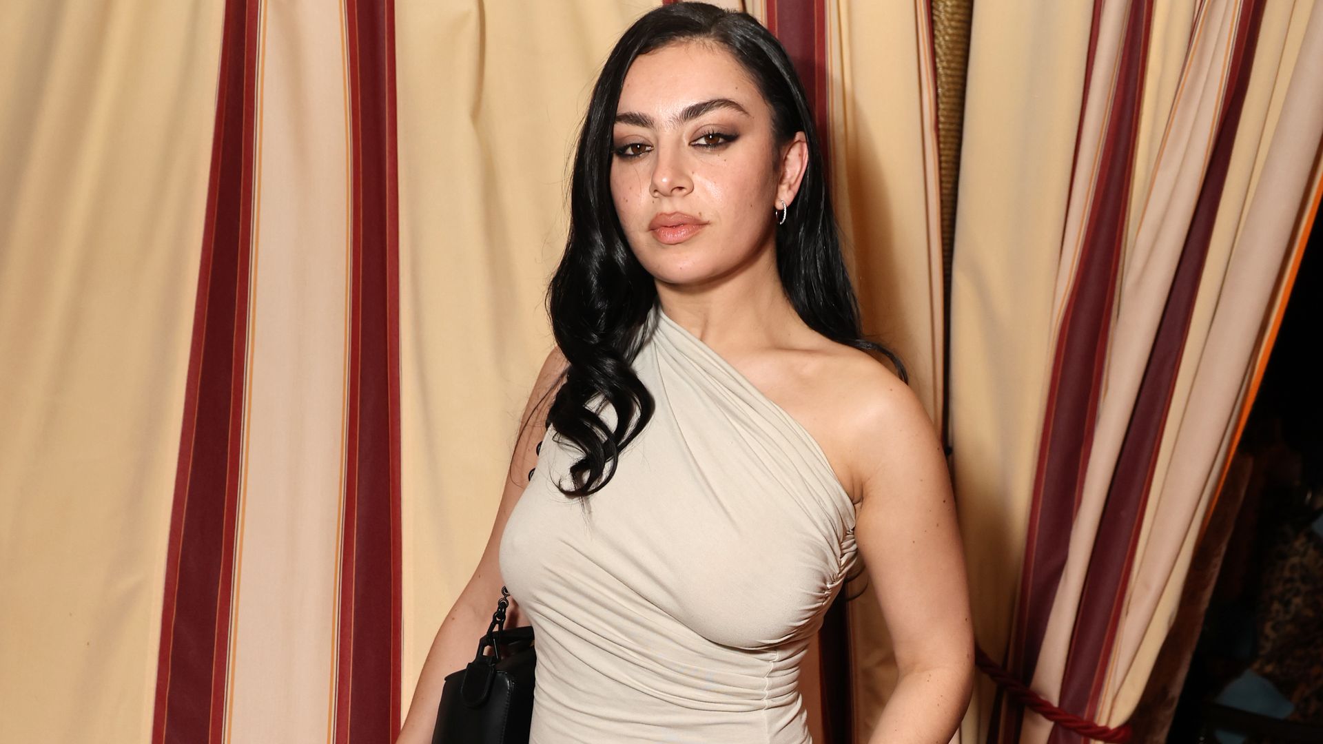 Charli XCX nails grunge glam in draped top and boyfriend jeans