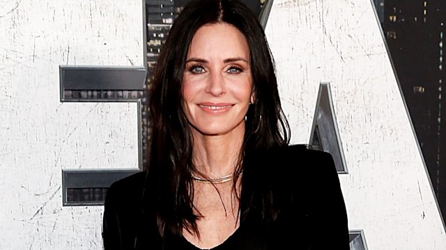 Courteney Cox smiling at a red carpet event