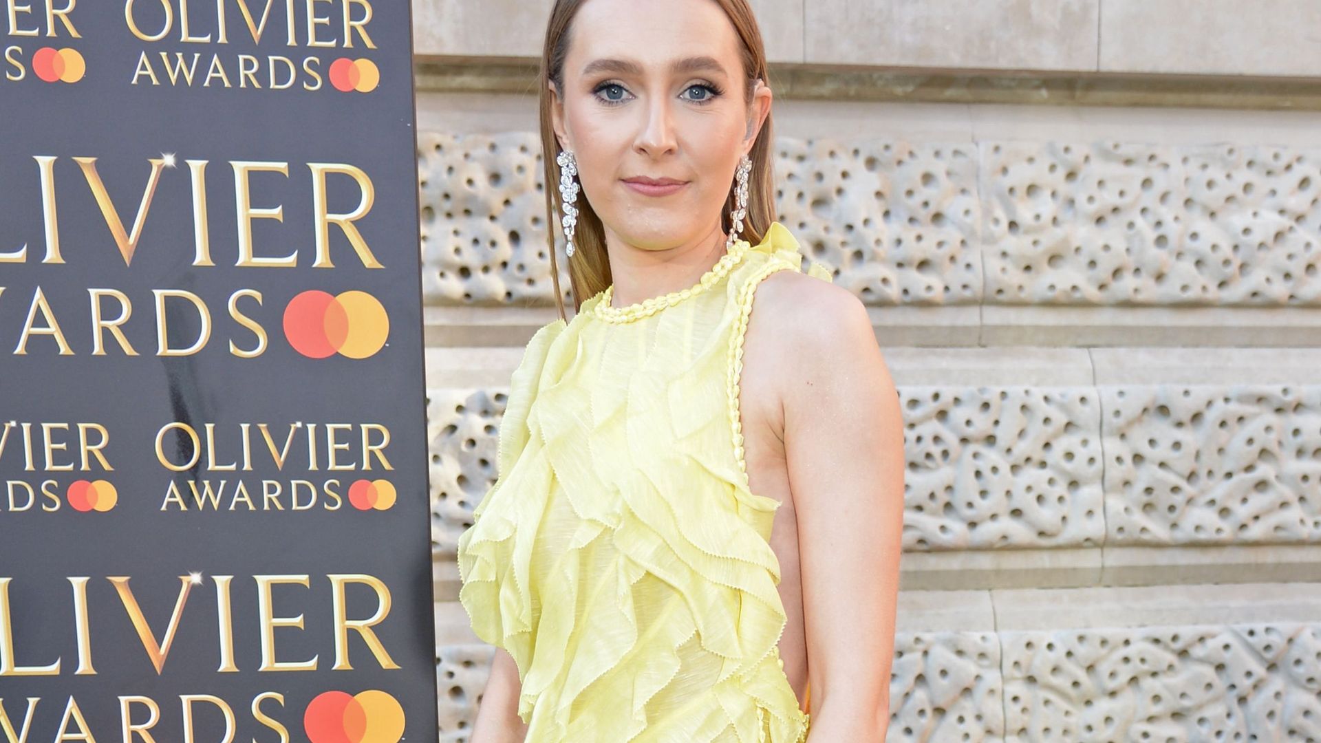 rose ayling ellis in a yellow ruffled gown 