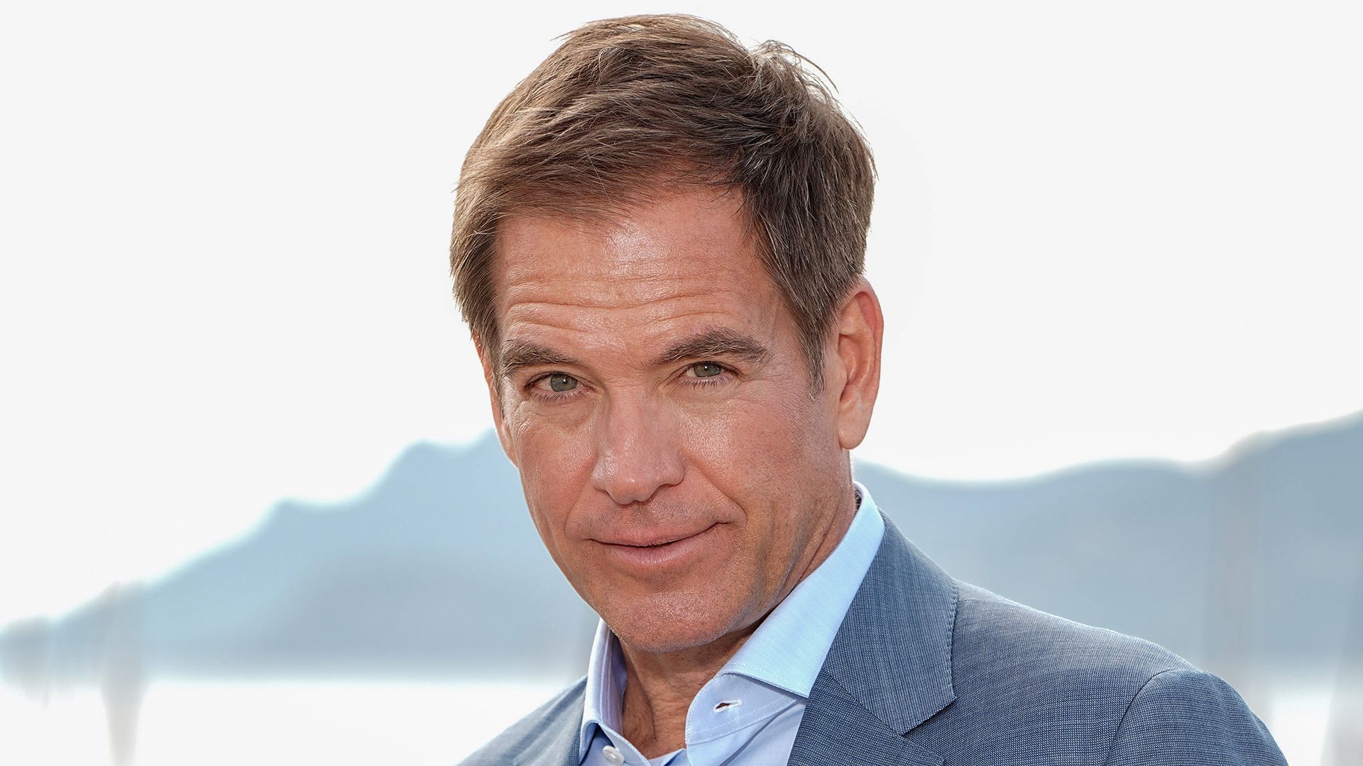 Michael Weatherly wearing a blue suit and shirt as he poses in Cannes