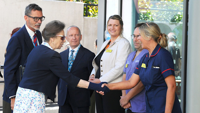 Princess Anne wearing gloves and sunglasses to shake hands with healthcare workers