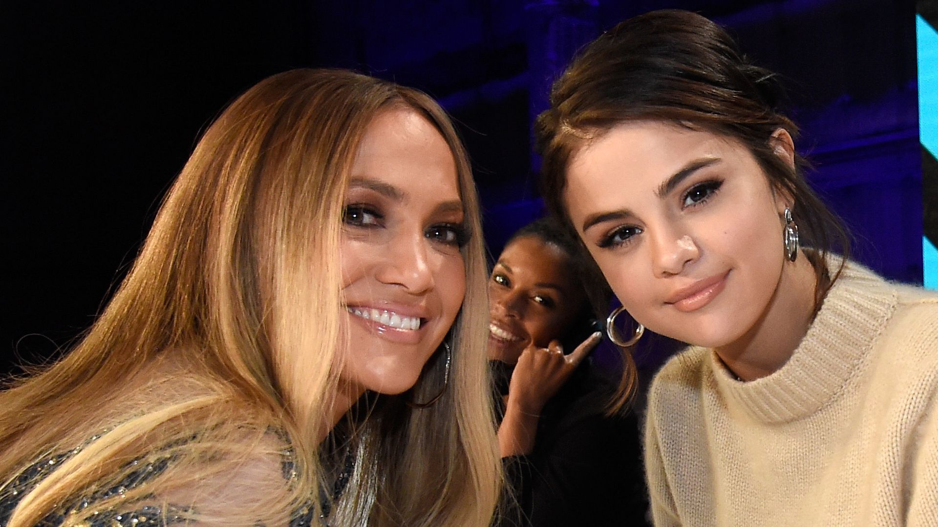  In this handout photo provided by One Voice: Somos Live!, singers Jennifer Lopez and Selena Gomez and actor Vanessa Hudgens participate in the phone bank onstage during "One Voice: Somos Live! A Concert For Disaster Relief" at the Universal Studios Lot on October 14, 2017 in Los Angeles, California.  (Photo by Kevin Mazur/One Voice: Somos Live!/Getty Images)
