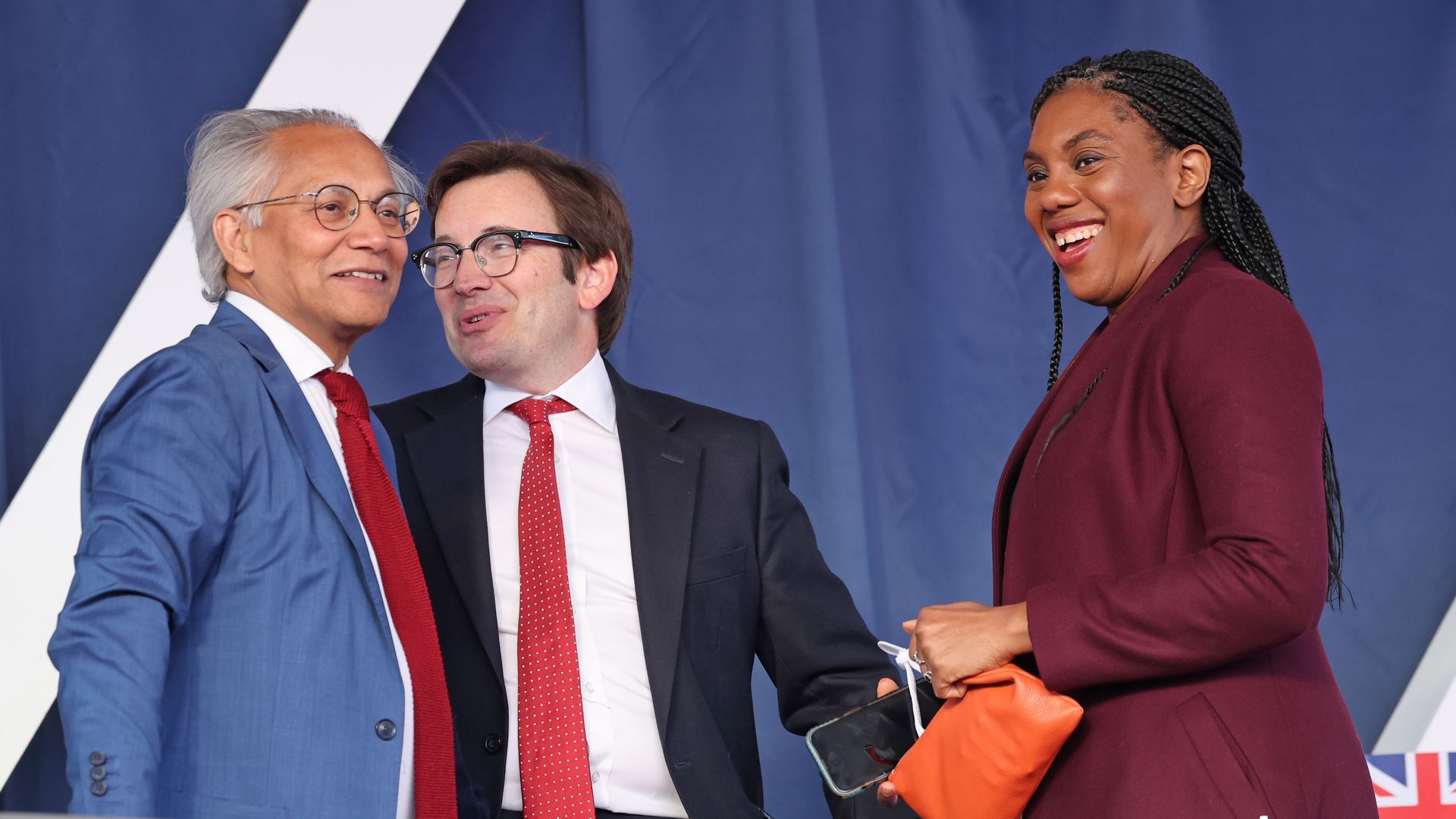 Kemi Badenoch laughing with two men