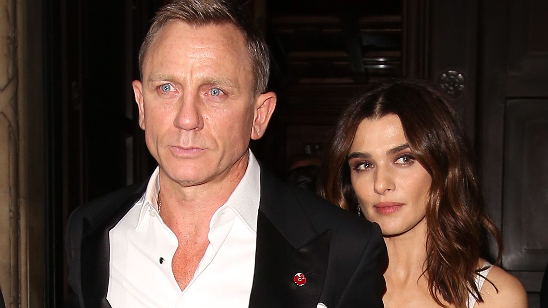 Daniel Craig in a suit and Rachel Weisz in a floral dress attending the Spectre Premiere after party in 2015