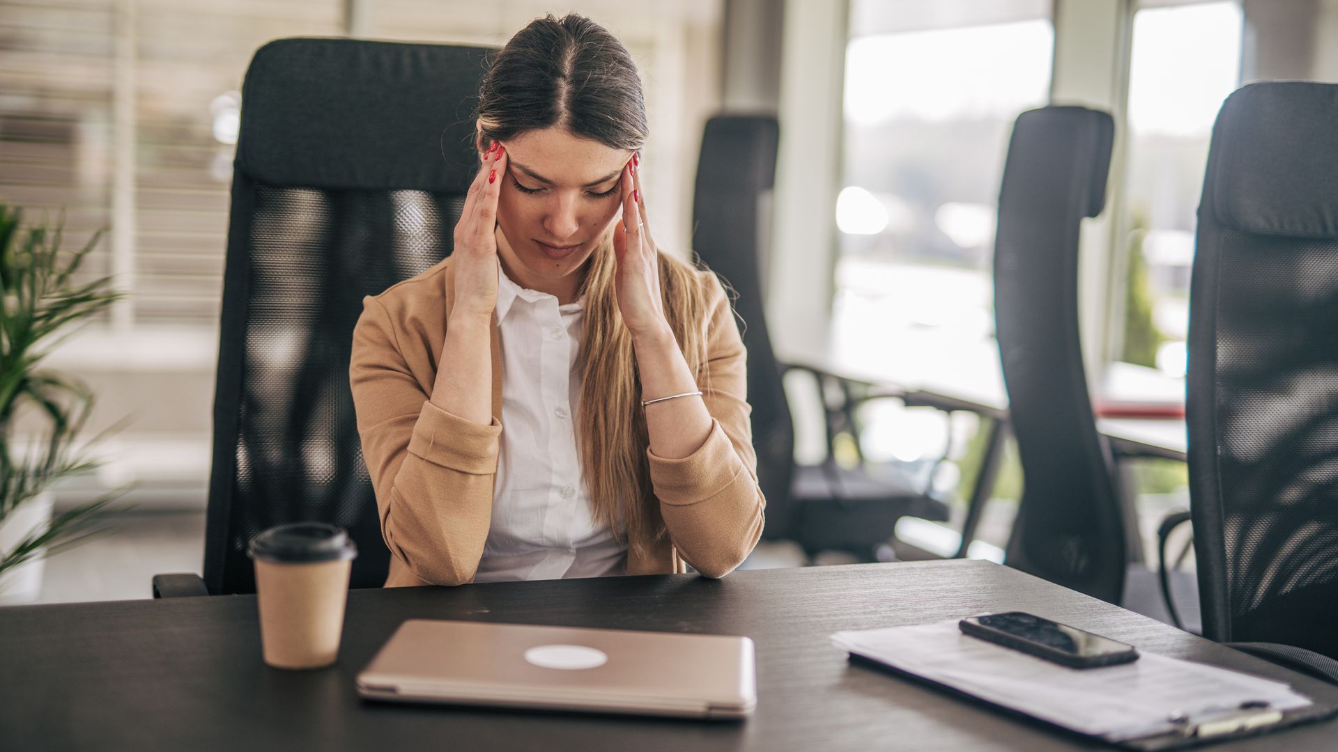 woman with headache at the office