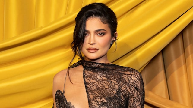 Kylie Jenner wearing an asymmetric lace dress during Paris Fashion Week 