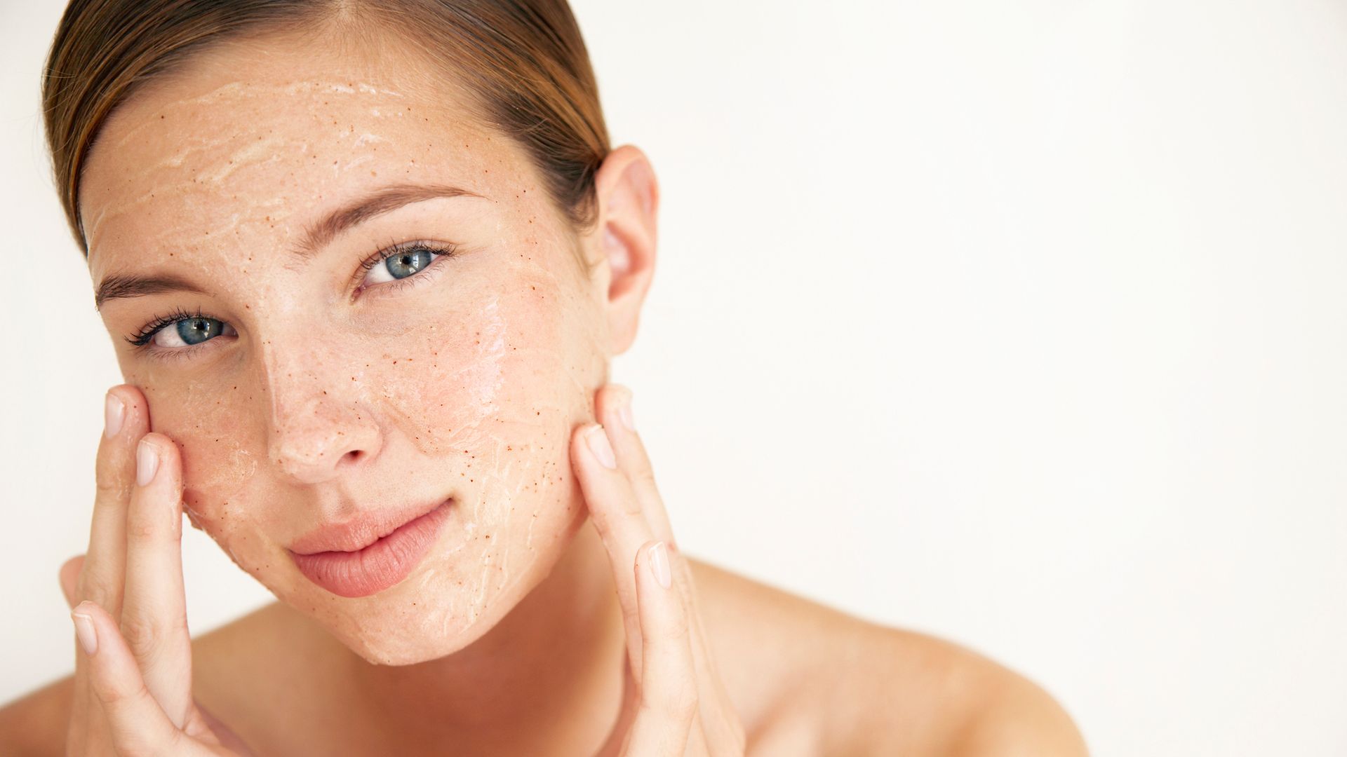 Getty Image Woman using face scrub, skincare