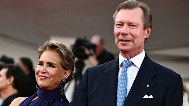 couple linking arms on red carpet