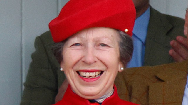 Princess Anne smiling in red