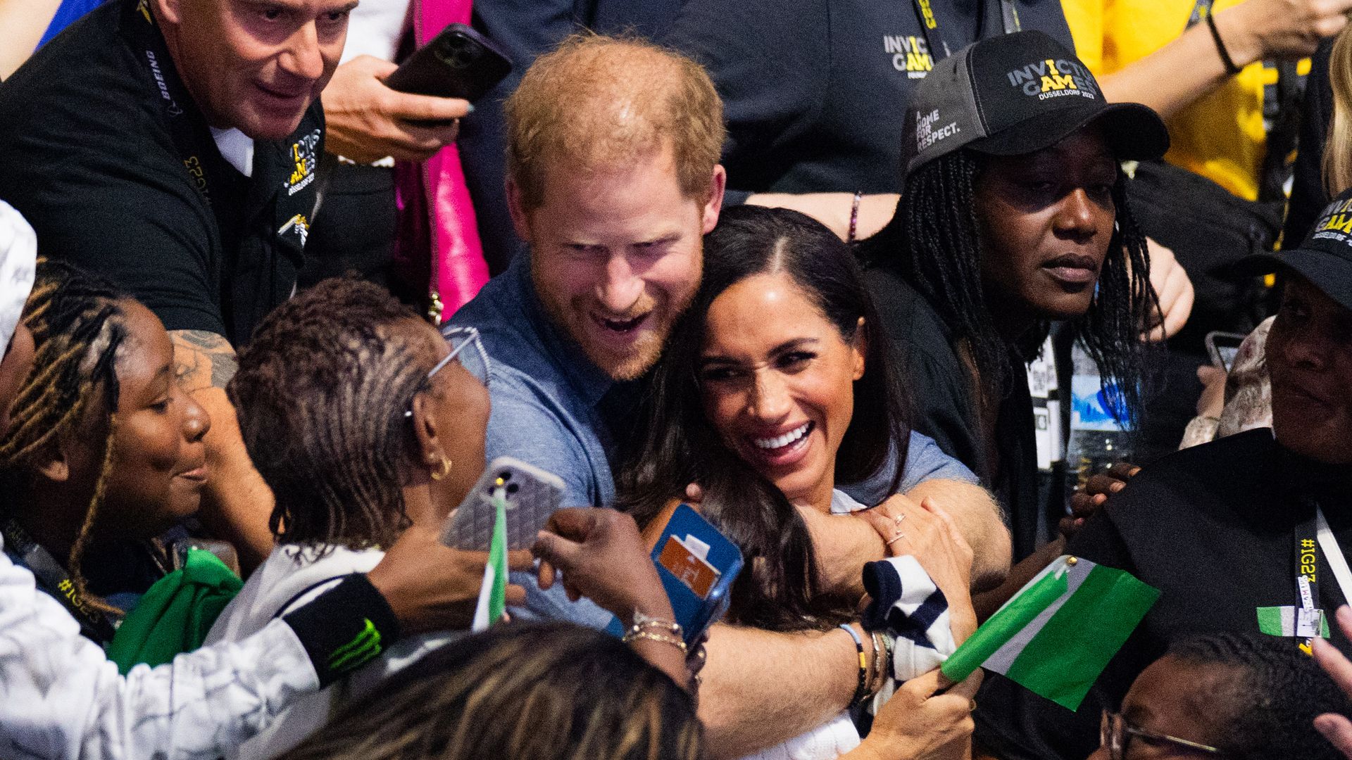 Prince Harry hugs wife Meghan as they watch sitting volleyball at the Invictus Games