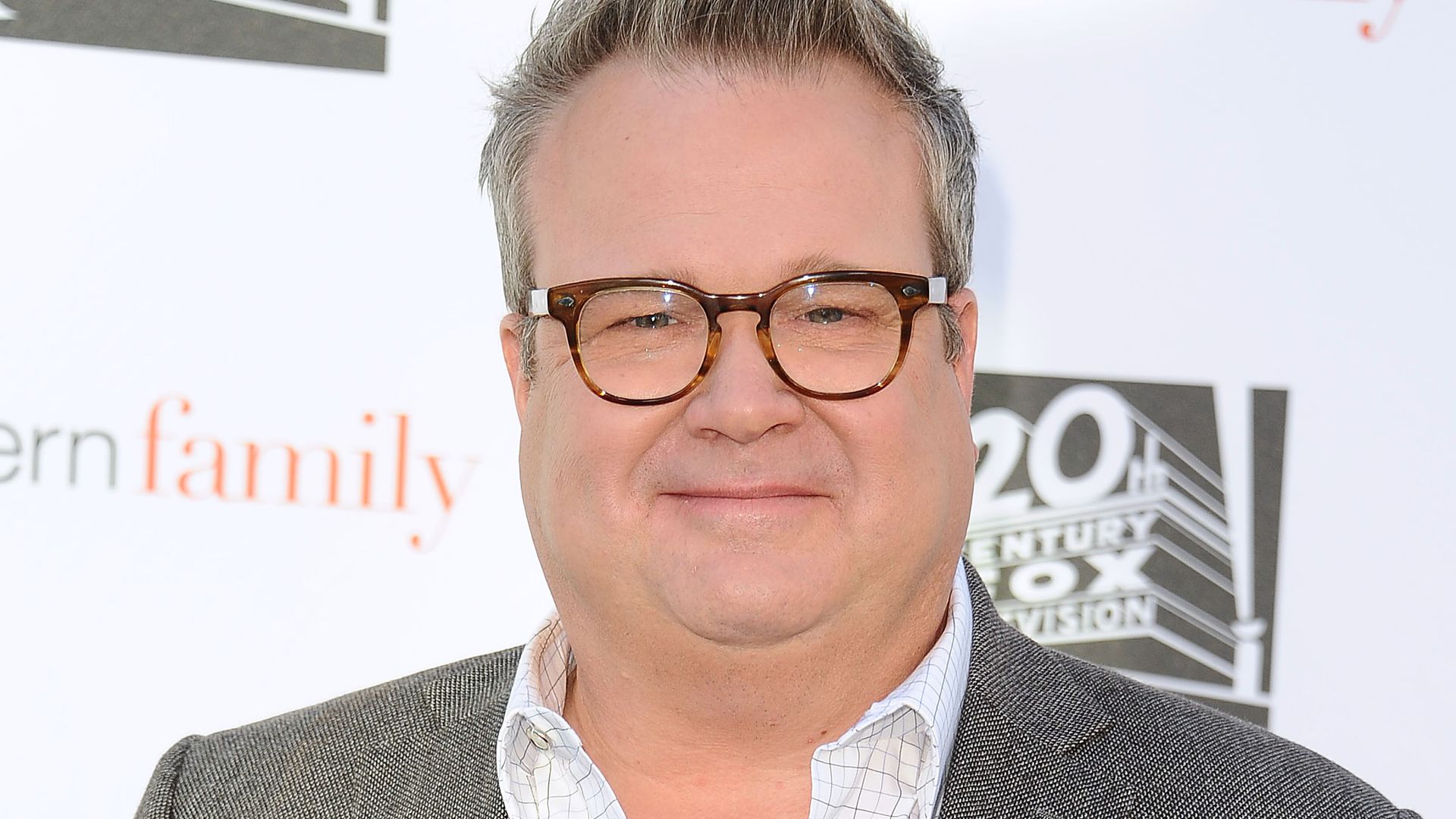 photo of eric stonestreet in gray auit