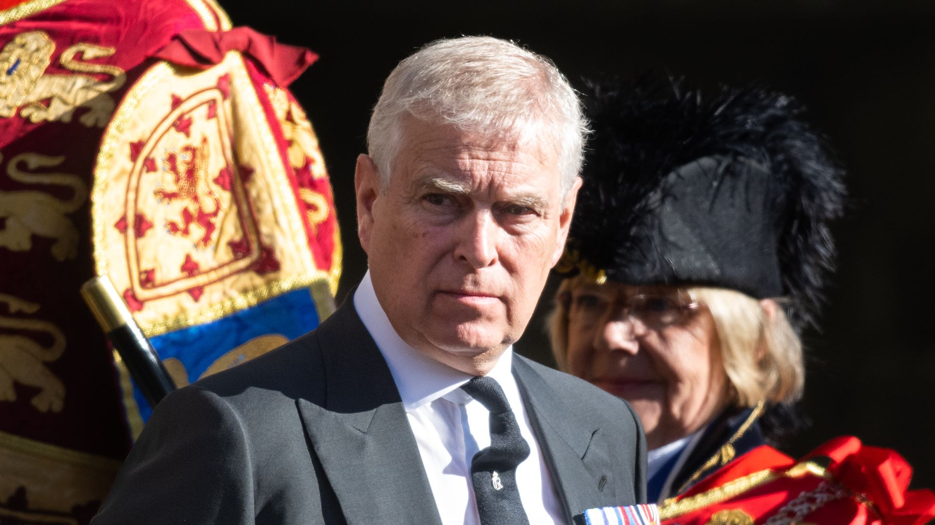 Prince Andrew wearing a charcoal suit 