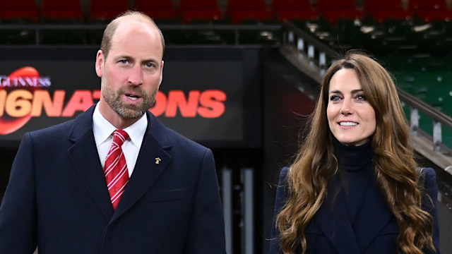 Prince William and Kate Middleton walking through a stadium