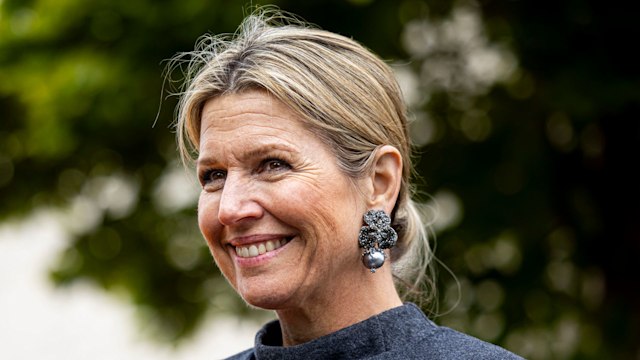 Queen Maxima smiling in grey cape