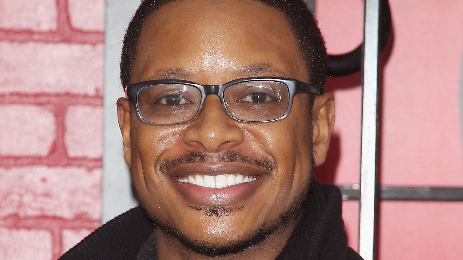 Close up of Arjay Smith wearing glasses