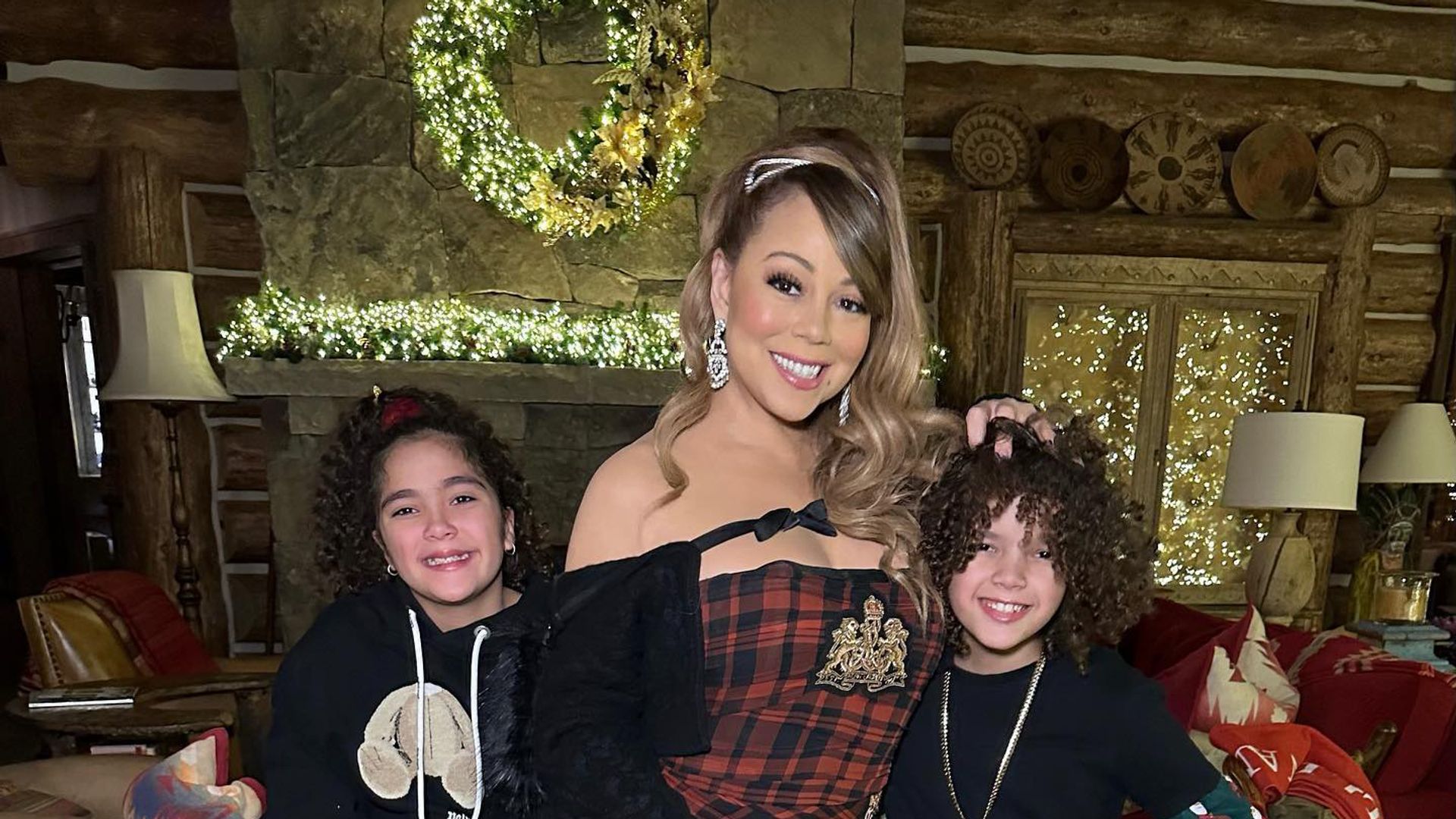 Mariah Carey standing with twins Morrocan and Monroe. 