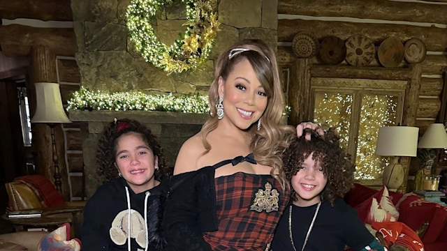 Mariah Carey standing with twins Morrocan and Monroe. 
