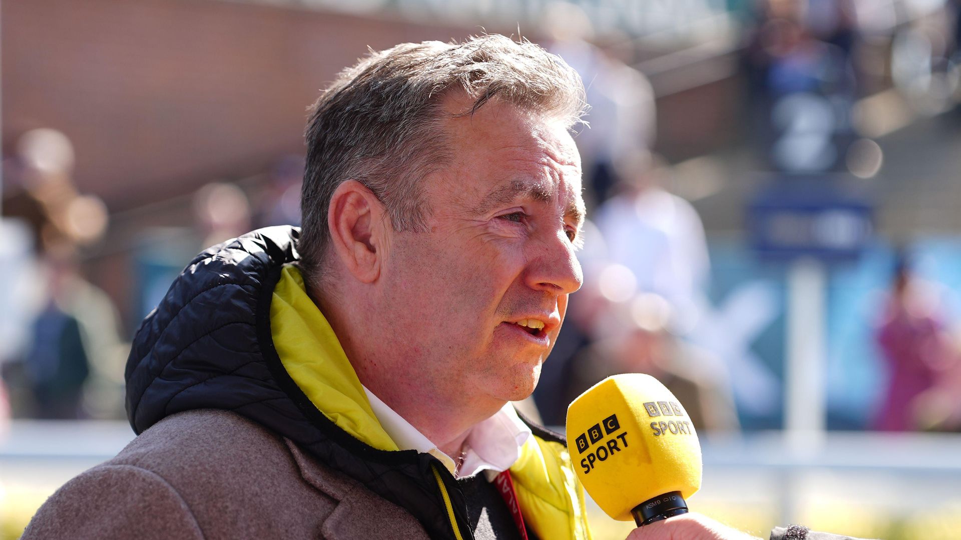 John Hunt speaking into a BBC sport microphone