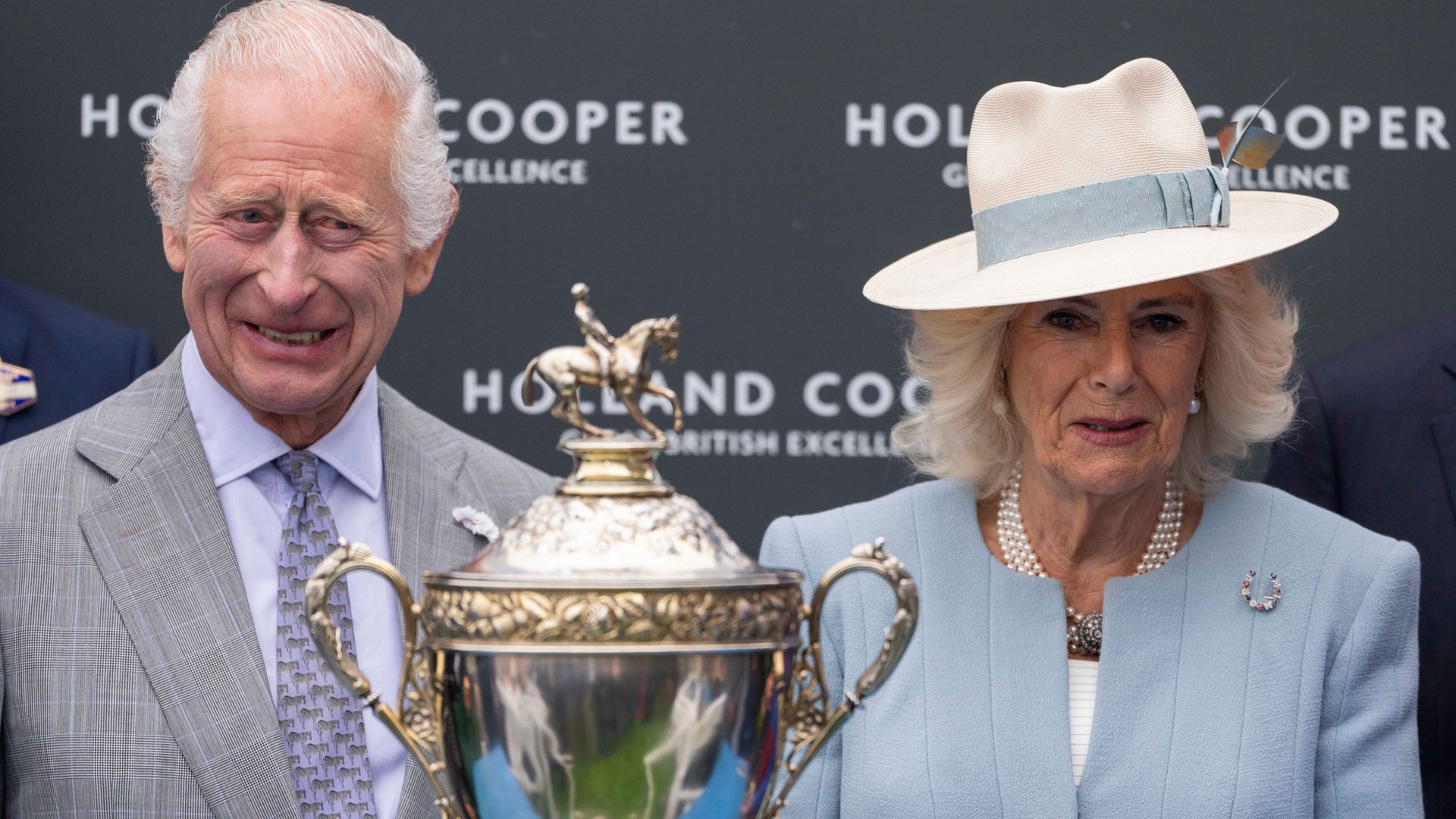 King Charles and Queen Camilla with a trophy