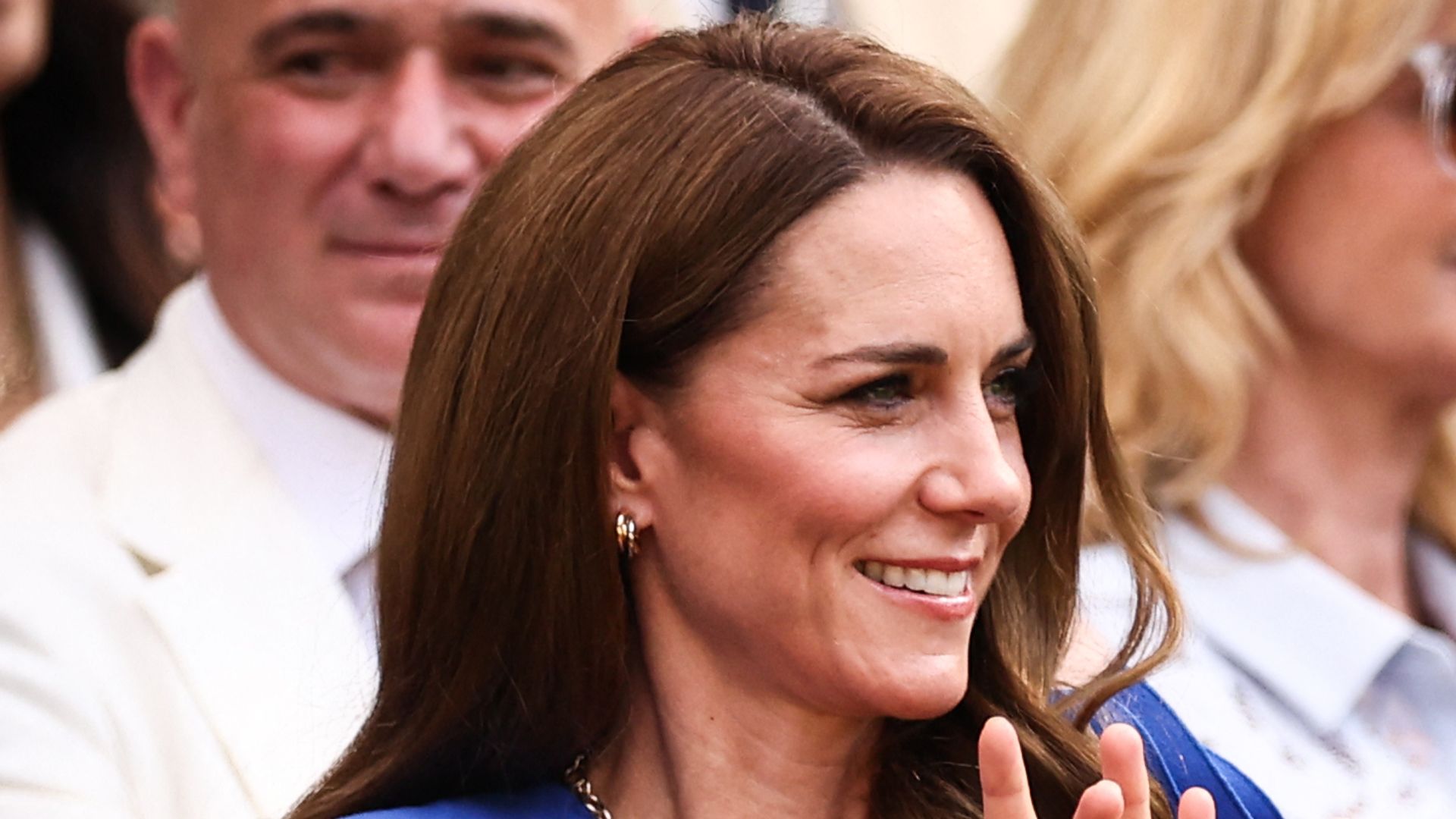 Catherine, Princess of Wales clapping in royal blue dress 