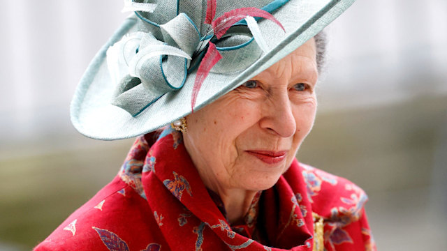 Princess Anne in red printed coat and blue hat