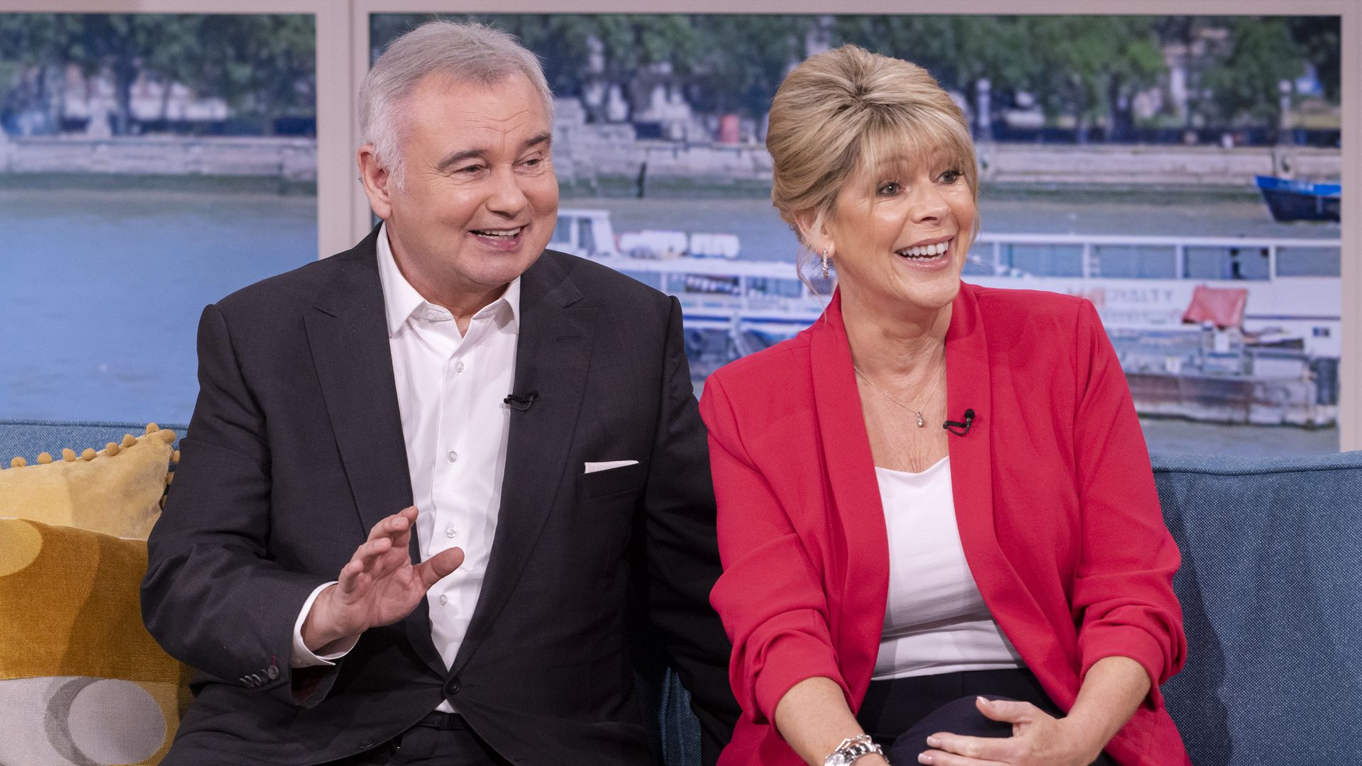 Eamonn Holmes in black suit and Ruth Langsford in red blazer on set of This Morning