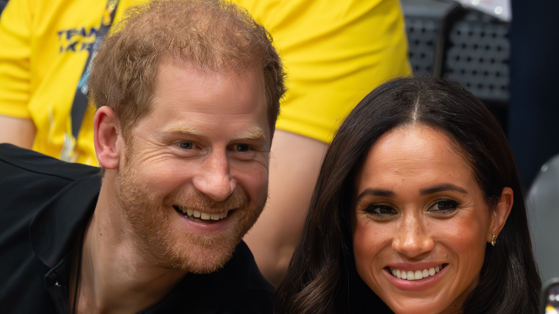 Harry and Meghan smiling at Invictus Games 2023