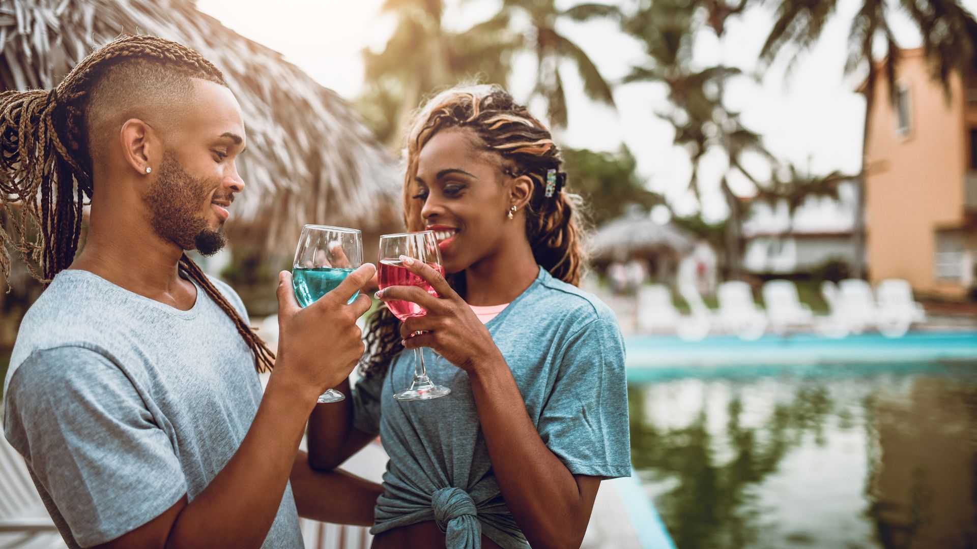 Young Couple Making Cocktails Toast In A Tourist Resort