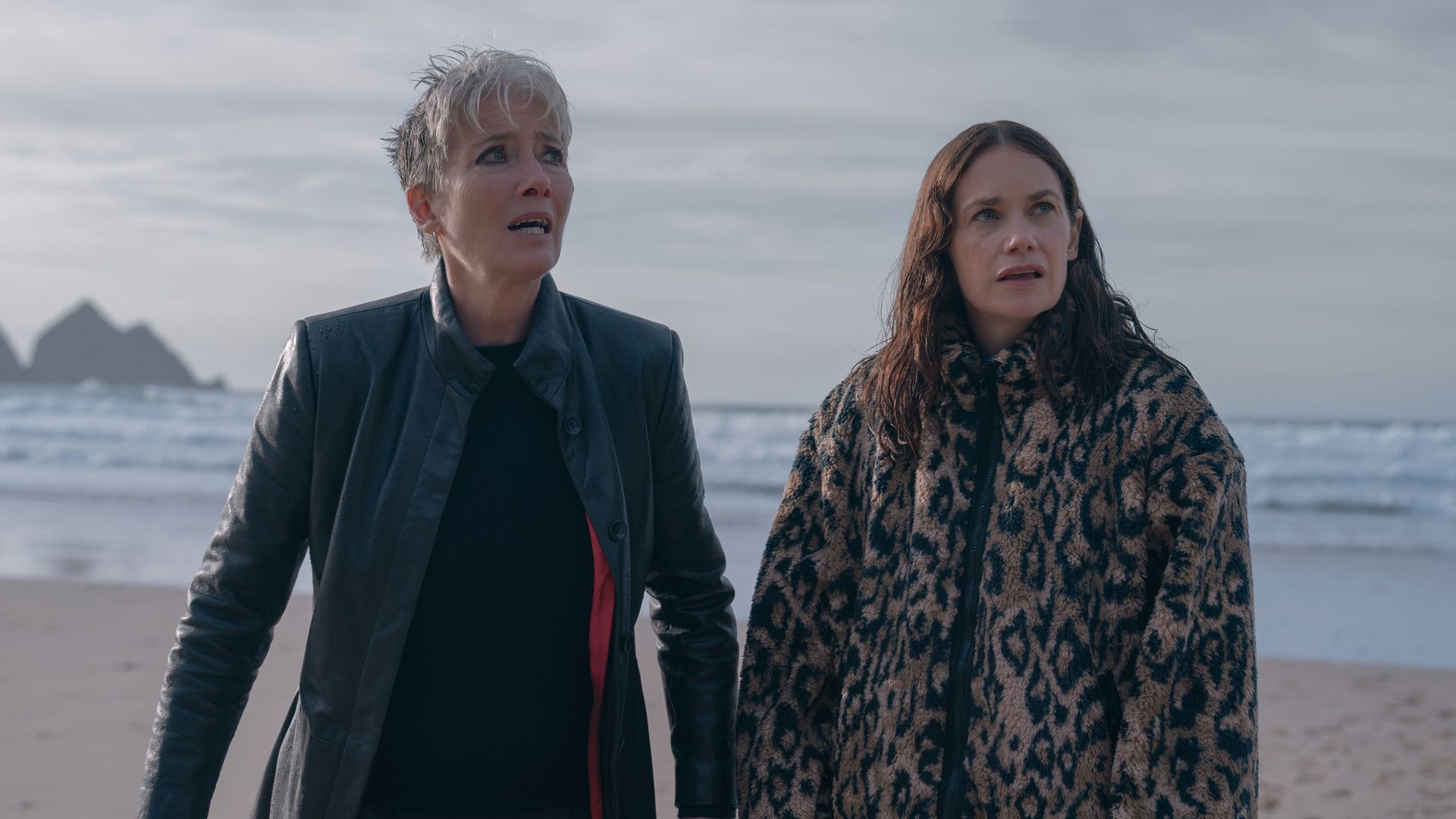 two women standing on beach