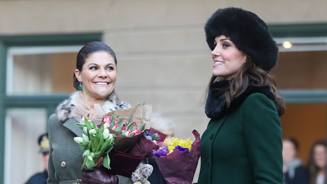 Kate and Princess Victoria of Sweden walk through the cobbled streets of Stockholm 