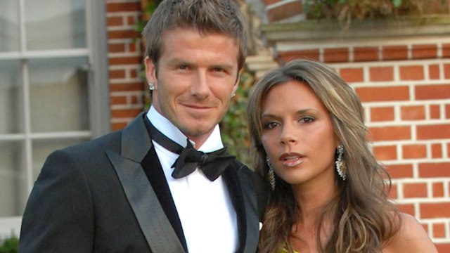 David Beckham in a suit and Victoria in a yellow dress