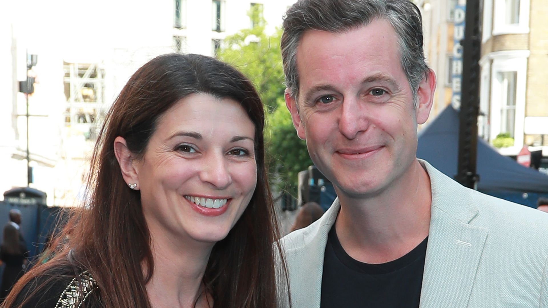 Matt Baker in a pale jacket with his wife Nicola in a black outfit
