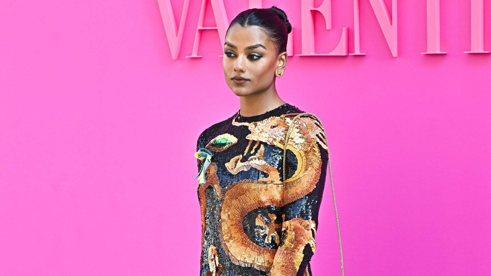 Simone Ashley attends the Valentino Womenswear Fall/Winter 2022/2023 show as part of Paris Fashion Week in colourful mini dress