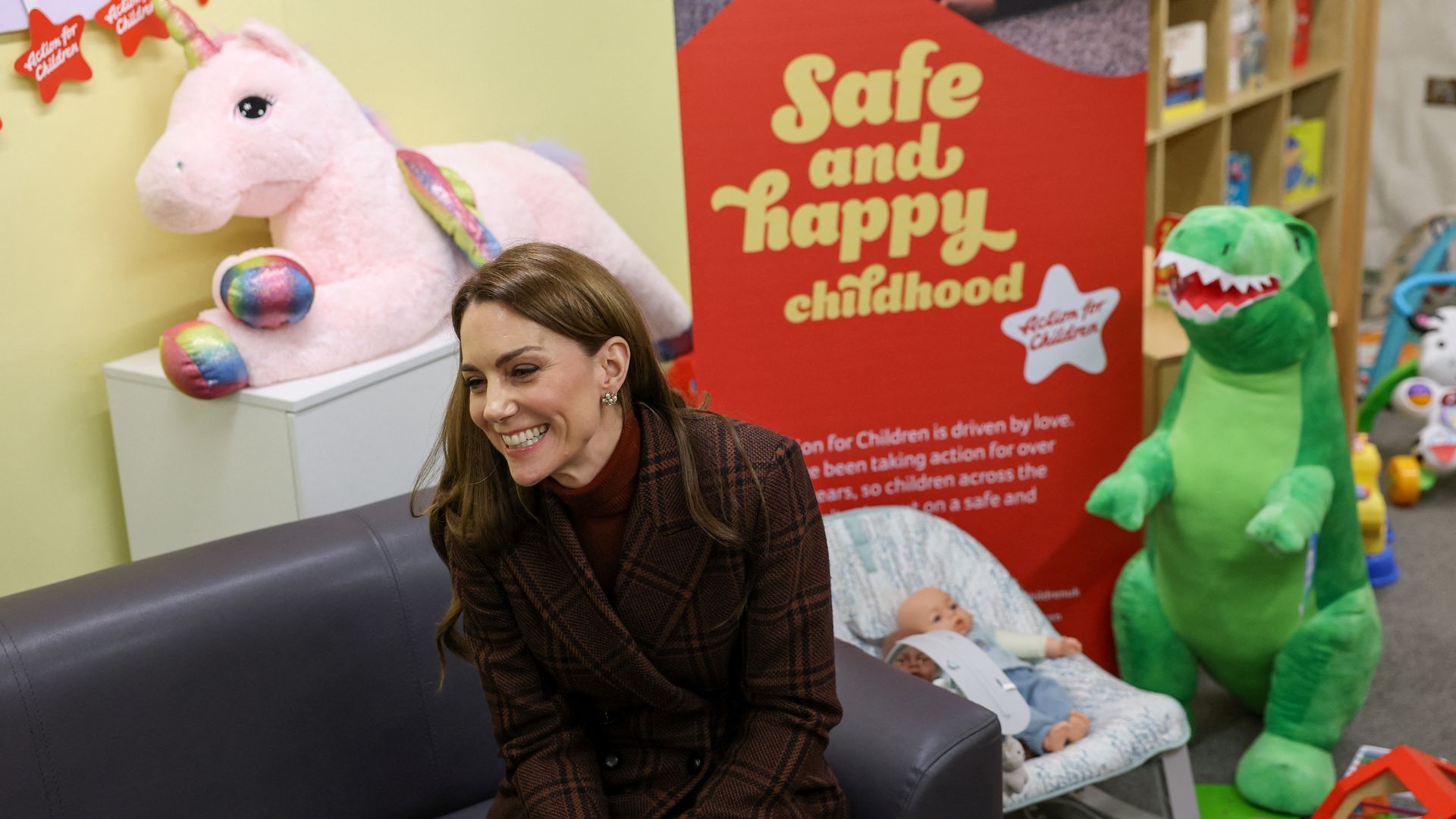 Kate Middleton in front of toys in mother and baby unit
