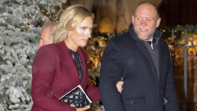 Zara Tindall and Mike Tindall walking past a Christmas tree