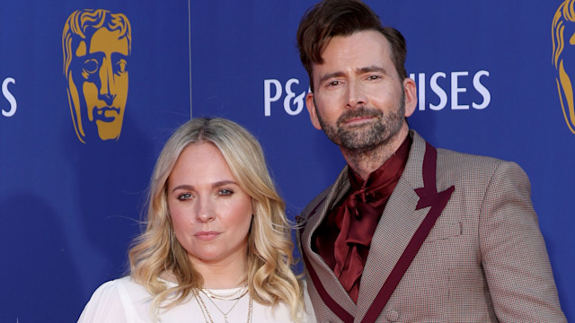 Georgia Tennant in a white dress on the red carpet with David Tennant