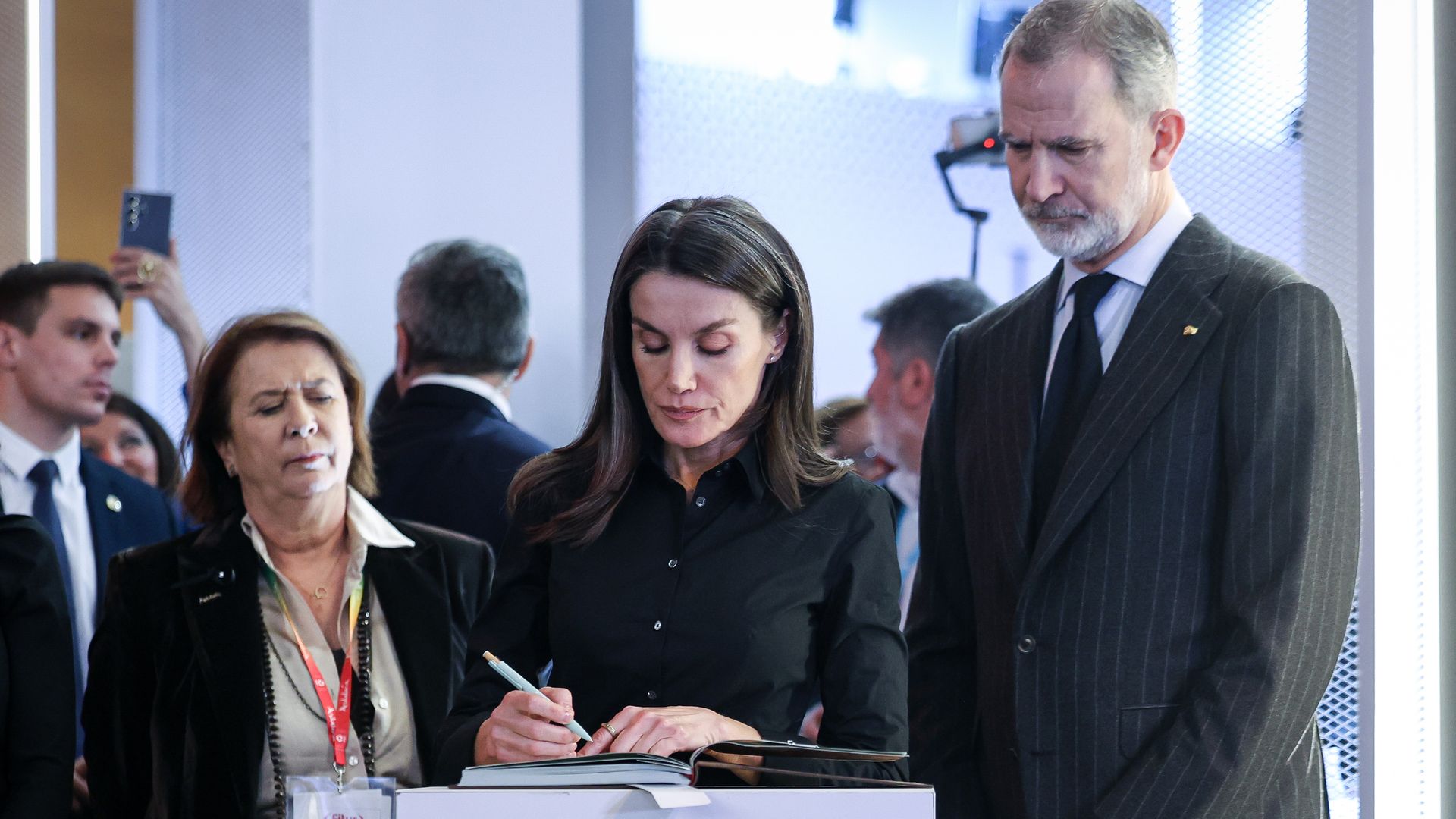 Queen Letizia of Spain signs a book of condolences in Madrid with husband King Felipe