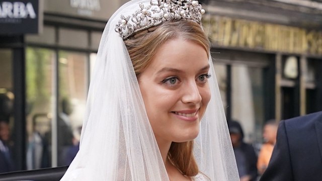 Flora Ogilvy smiling in a wedding dress and tiara