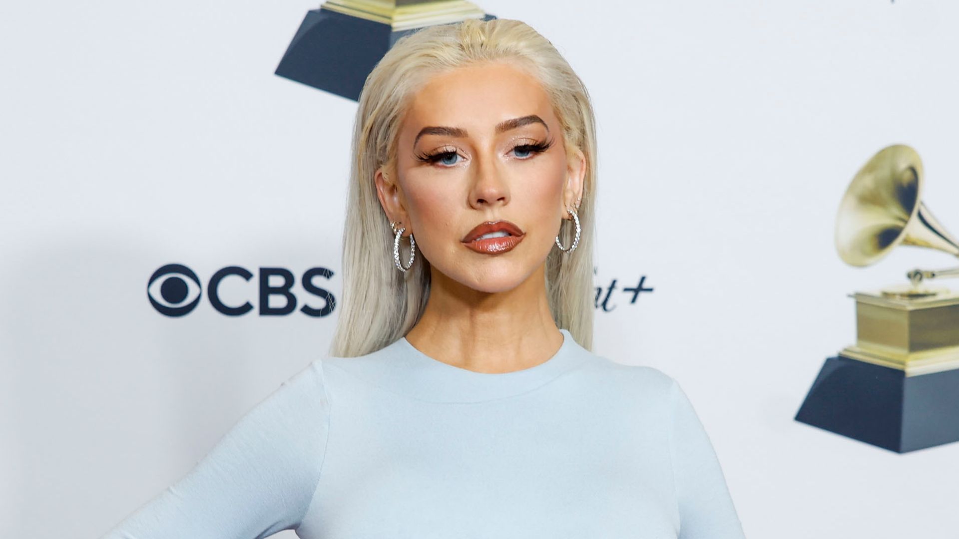 Christina Aguilera shows off svelte new look in tight ice blue dress