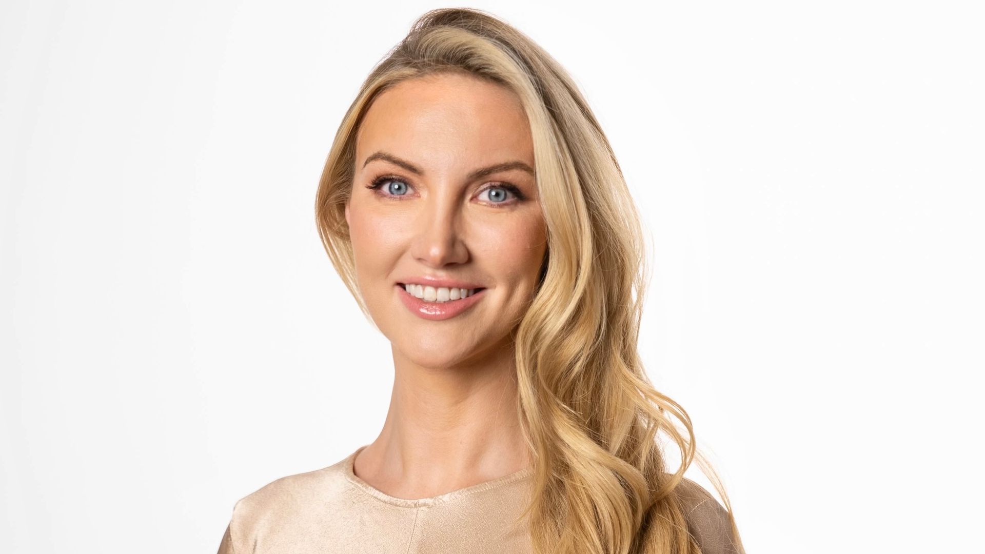 headshot of Dr Leah Totton in gold dress