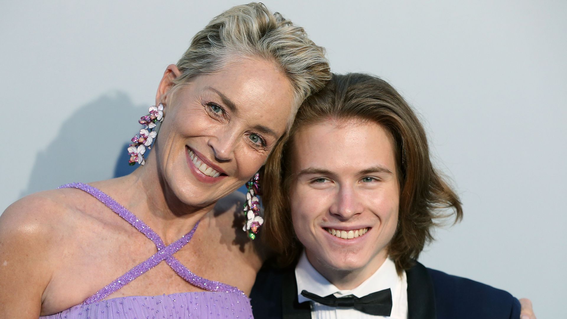 A close up photo of Sharon Stone with her head on son Roan's head