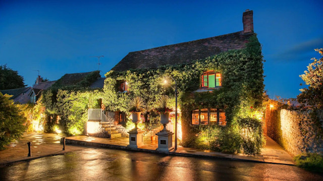 A Cotswolds pub lit up in the night 